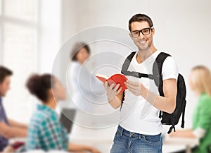 Travelling student with backpack and book