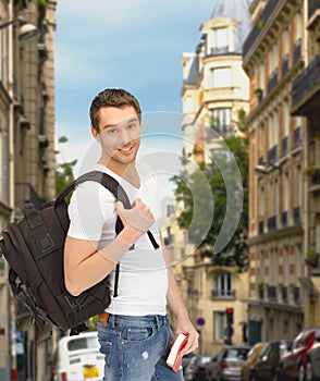 Travelling student with backpack and book