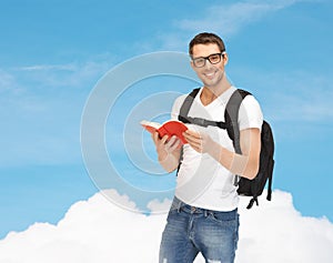 Travelling student with backpack and book