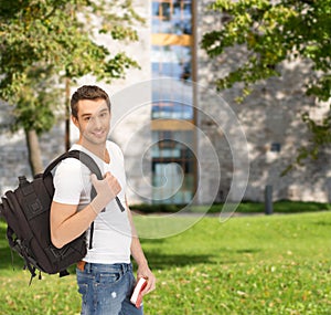 Travelling student with backpack and book