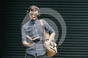 Travelling student with backpack and book. travel concept