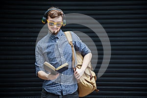Travelling student with backpack and book. travel concept