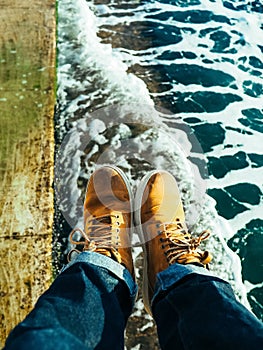 Travelling wearing yellow shoes at the seashores photo