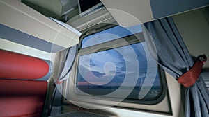 Travelling by train concept. Evening scenery seen through the train`s window in a cabin