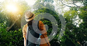 Travelling woman with backpack enjoying on exploring and trekking in tropical rain forest of Asia, Tourist traveler on background