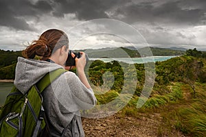 Travelling woman photographer with backpack photo