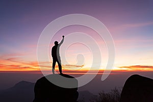 travels Silhouette on the peak of mountain,success concept