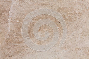 Travertine. Classic warm beige color with a pronounced banding and heterogeneity of pattern. photo