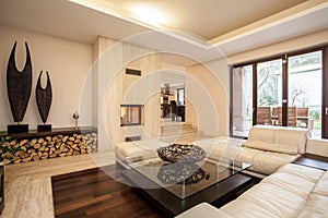 Travertine house: beige living room