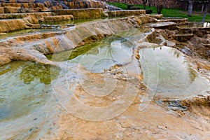 Travertine terraces with hot water of Karahyit Red Springs, Turkey