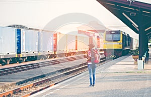 Travler women walking alone Carrying luggage and waits train
