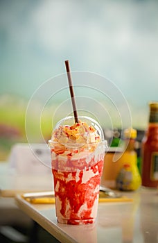 Trawberry and passion fruit smoothie mix in a glass.
