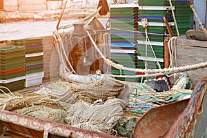 Trawl, pelagic boards, fishing net and boxes for fish lies on the fishery deck of a small fishing seiner