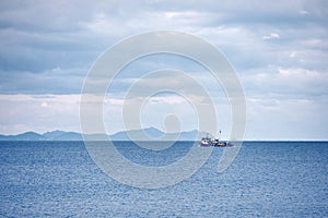 Trawler fishing boat sailing over the calm sea