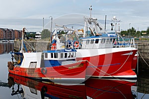 Trawler fishing red boat at Peterhead harbour in Scotland photo