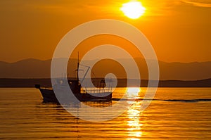 Trawler in the glow of the setting sun.