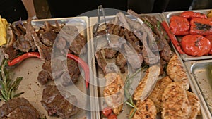 Tray with cooked food on showcase at cafeteria.