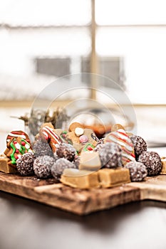 tray of cookies on a table by window with christmas decorations