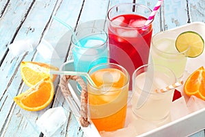 Tray of cool summer drinks against rustic blue wood