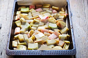 Tray with cut rhubarb and golden sugar