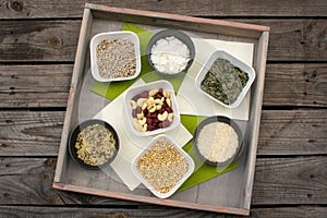 Tray with different types of grains and rice in small bowls
