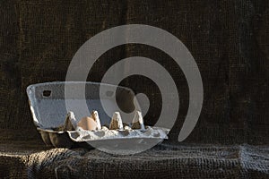 Tray of eggs with one egg