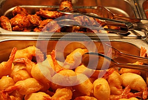 Tray filled with fried meat and fish within the self service res