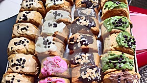 a tray filled with various delicious breads and cakes. The breads and cakes come in all shapes and sizes, and are all topped.