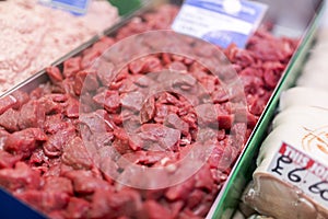 Tray of finest beef stewing steak laid out on a market stall in