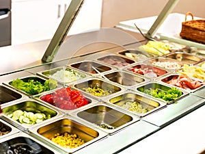 Tray with food on showcase at cafeteria