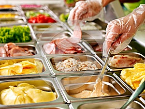 Tray with food on showcase at cafeteria