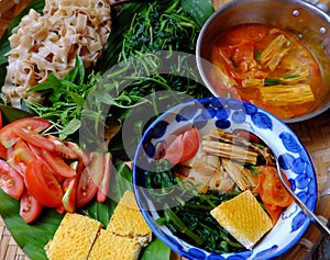 Tray of food for vegetarian breakfast, homemade Vietnamese dry pancake noodles soup