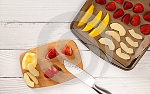 Tray of Fruit Being Prepared to Dehydrate on a Wooden Table