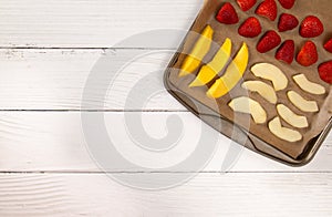 Tray of Fruit Being Prepared to Dehydrate on a Wooden Table