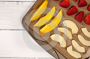 Tray of Fruit Being Prepared to Dehydrate on a Wooden Table