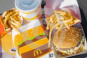 tray full of fast food in McDonalds Restaurant, Big Mac Menu with McDonalds logo box, Cheeseburger, French fries, Cola