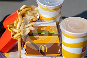 tray full of fast food in McDonalds Restaurant, Big Mac Menu with McDonalds logo box, Cheeseburger, French fries, Cola