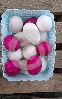 A tray full of red and white eggs