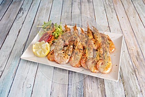 Tray of great grilled fried prawns with spurts of lemon, garlic and parsley, photo