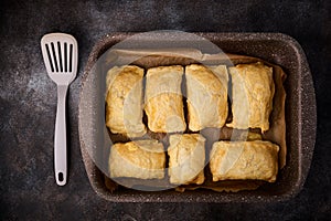 Tray with hot puff pastry patties with cheese, top view, close up