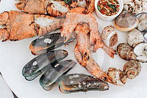 Tray of mussel, shrimp,prawns and clams with spicy and sour dipping sauce that is packed full of Thai seafood flavor.