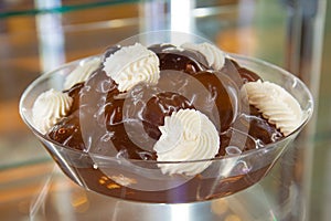 Tray of profiteroles with cream and chocolate.