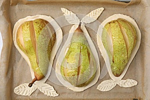 Tray with raw dough and fresh pears, flat lay
