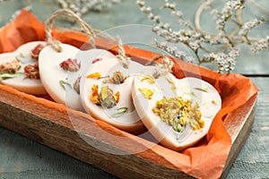 Tray  with scented sachets on blue wooden table, closeup