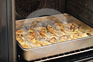 Tray with seasoned sliced king trumpet mushrooms pleurotus eryngii, potatoes and onions in the oven