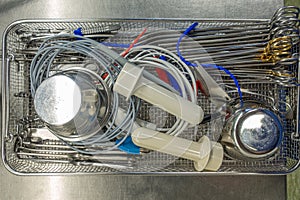 tray for surgical instruments contains various assorted instruments for performing an operation