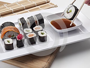 Tray with sushi results and one with chopsticks in the foreground photo