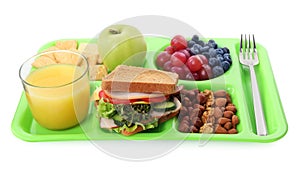 Tray with tasty food and juice on white background. School lunch