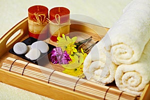 Tray of towels, candles and pebbles - spa