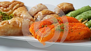 A tray of Turkish pastries including baklava, knafeh -  a Middle Eastern cheese pastry soaked in sweet, sugar-based syrup